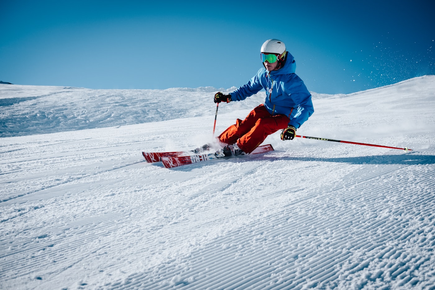 Skier carving on a groomed slope
